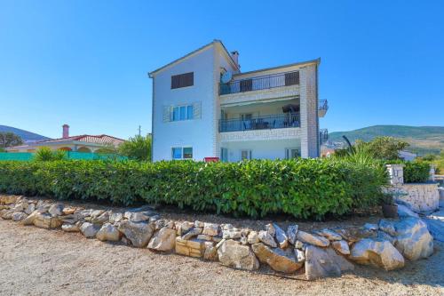 a house on the beach with a stone wall at Villa Olivia Trogir in Trogir