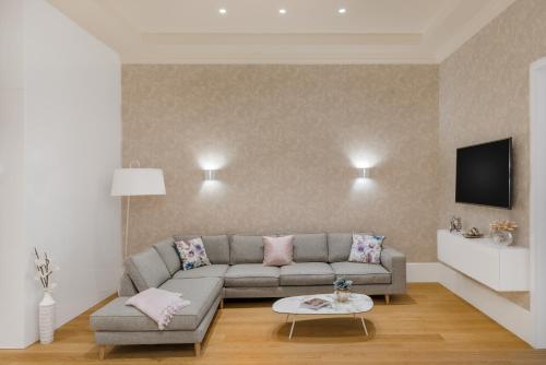 a living room with a couch and a tv at Hotel Vision Budapest by Continental Group in Budapest