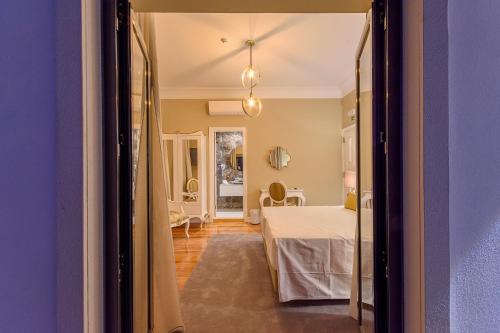 En eller flere senge i et værelse på Villa Mariazinha Charming Hotel