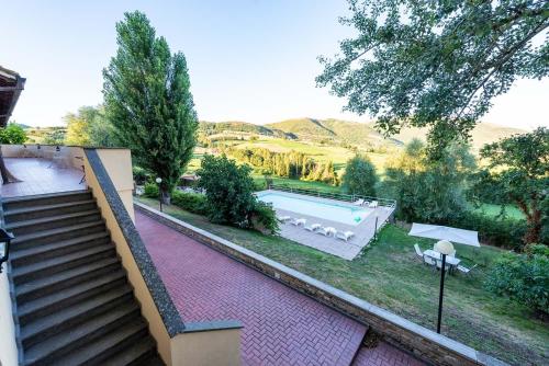 a house with a swimming pool in a yard at Abadia Farneto in Gubbio