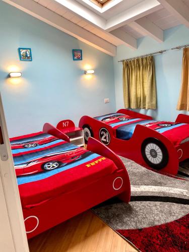 two beds in a room with two cars beds at ABCdecor Italia in Imperia