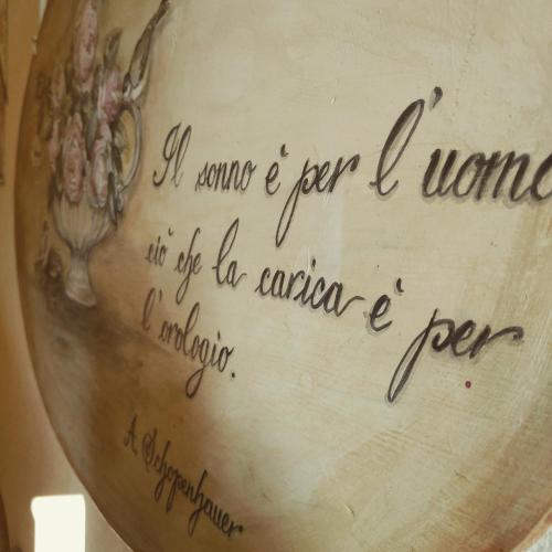 a vase with writing on the side of it at B&B Casa Camilla in Padova
