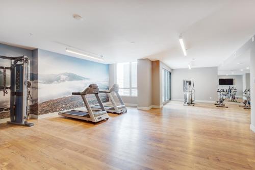 a gym with cardio equipment in a building at L'Equinox Modern Apartments by Corporate Stays in Laval