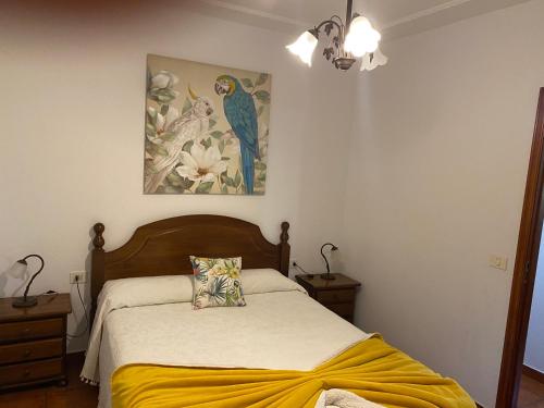 a bedroom with a bed with a yellow blanket on it at Taburiente in Tijarafe