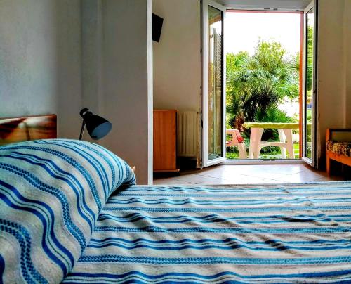 a bedroom with a bed with a view of a patio at Casa Miralago in Menaggio