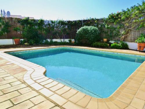 a swimming pool in a yard next to a fence at Casa Rosa Floresta in Luz