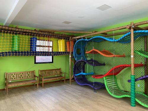 a childrens play room with a slide at Hotel Metrópole in São Lourenço