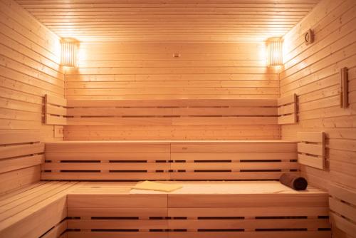 a wooden sauna with a bench in the middle at Hotel TAMMEL in Jičín
