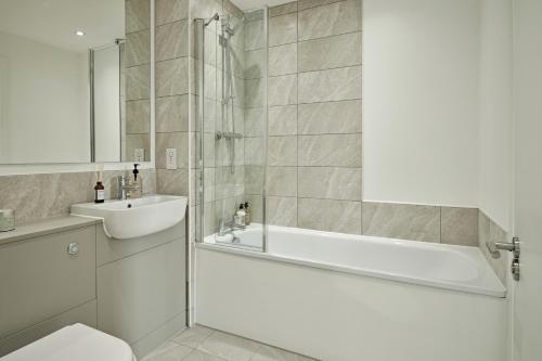 a bathroom with a bath tub and a sink at Manchester Media City by Charles Hope in Manchester
