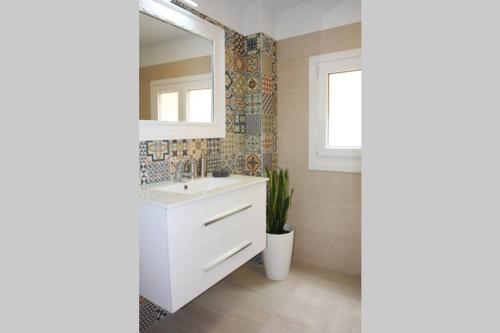 a bathroom with a white sink and a mirror at Apartamentos La Herradura Balcón in Haro