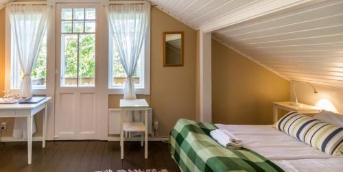 1 dormitorio con cama, escritorio y ventana en Hanko Villa Anke & Janne, en Hanko