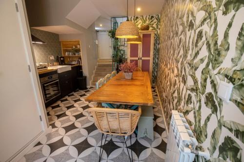 a kitchen with a wooden table and chairs at Secret Garden in Bragança - historic center in Bragança