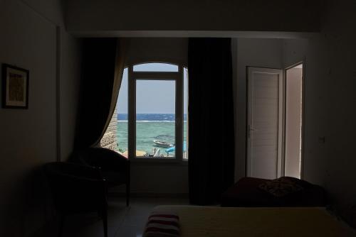 a bedroom with a window looking out at the ocean at Solaris in Dahab
