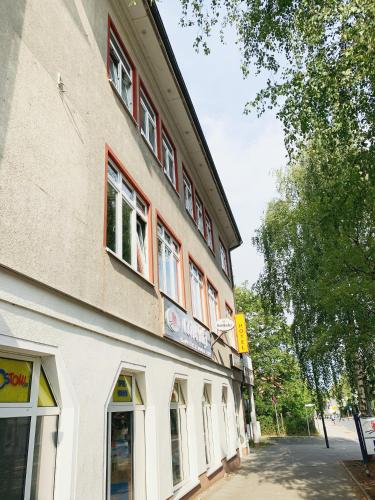 a building with windows on the side of a street at Hotel Birkenwerder in Birkenwerder