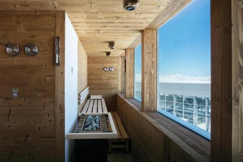 a wooden room with a bench and a window at CAPANNA PRESENA in Passo del Tonale