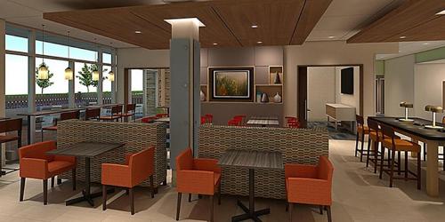 a restaurant with tables and chairs in a cafeteria at Holiday Inn Express & Suites - Carlisle Southwest I-81 by IHG in Carlisle