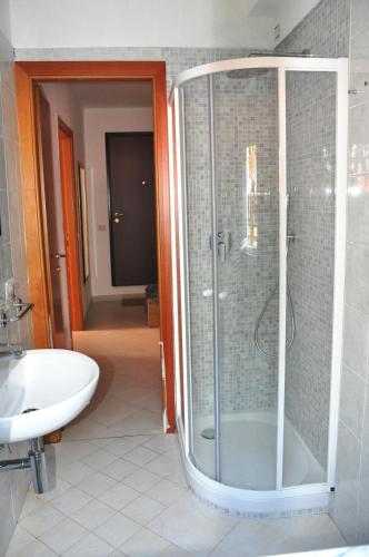a bathroom with a shower and a sink at Via Battisti 231 1 in Pietra Ligure