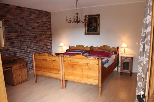 a bedroom with a large wooden bed with red pillows at Casa Rustica in Flonheim