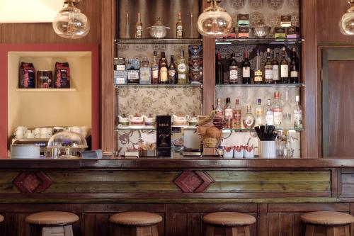 a bar with stools and bottles of alcohol at Ameliko Zagori in Ano Pedina