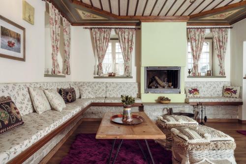 a living room with a couch and a table at Ameliko Zagori in Ano Pedina