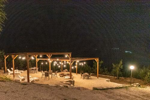 a pavilion with tables and chairs at night at Abadia Farneto in Gubbio