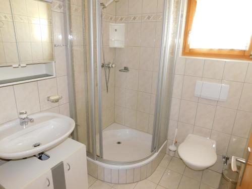 a bathroom with a shower and a sink and a toilet at Ferienwohnung Traumzeit EG in Bellwald