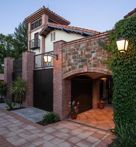 a brick house with a gate and a garage at Roman Spa Resort in Calistoga