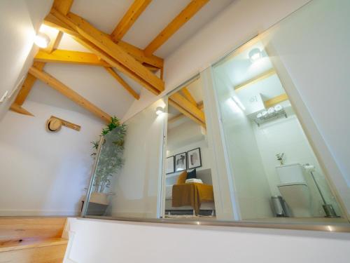 a large glass window in a room with wooden beams at Ponte D Luis I Apartments in Porto