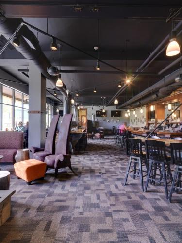 a room with chairs and tables in a building at Jay Peak Resort in Jay