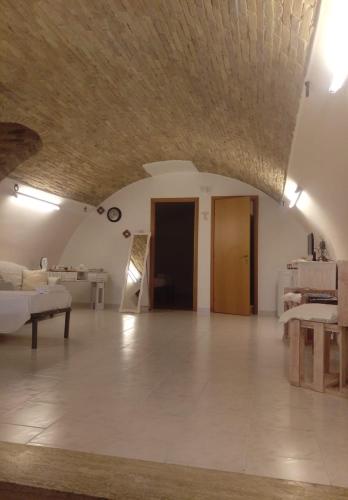 a large living room with a couch and a table at Residenza l'Orologio in Bernalda