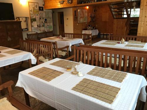 a restaurant with tables with white table cloths on them at Cabana Cota 1000 Arieseni in Arieşeni