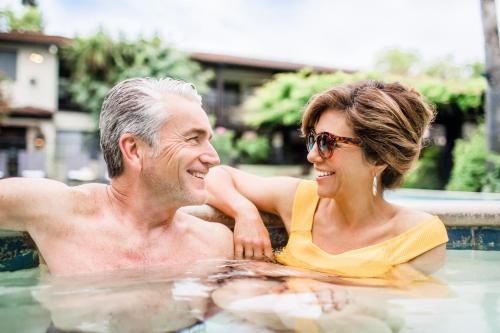 a man and a woman in a swimming pool at Roman Spa Resort in Calistoga