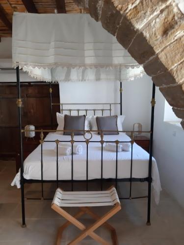 a bedroom with a canopy bed and a chair at Saint Antonio Maroni in Maroni