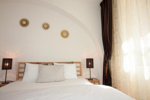 a bedroom with a white bed and two lamps at Villa Magdalena in Kutná Hora