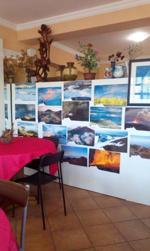 a wall with pictures on it in a restaurant at Villa Morgante B&B in Pedara