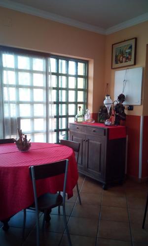 a kitchen with a table with a red table cloth at Villa Morgante B&B in Pedara