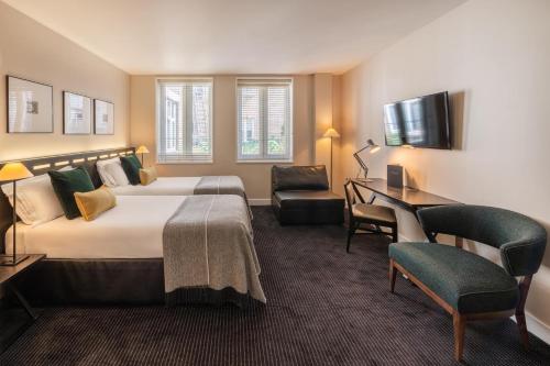 a hotel room with a bed and a desk at The Resident Soho in London
