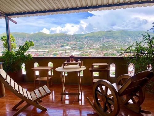a balcony with a table and chairs and a view at Terraza Cielito Lindo in Oaxaca City