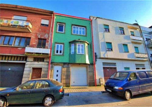 two cars parked in a parking lot in front of buildings at En-Suite Bedroom and Garage in Porto City Center in Porto