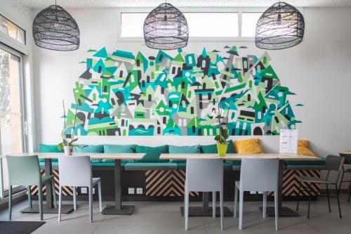 a dining room with a christmas tree on the wall at The People - Paris Bercy in Paris