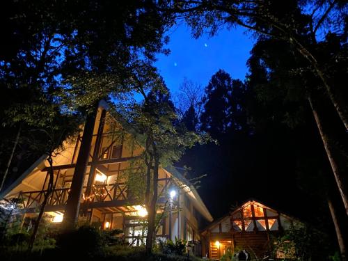 a house in the woods at night at 貸別荘MUSIC FOREST by MFR in Sasayama