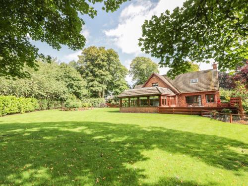 a house with a large lawn in front of it at Auburn Cottage in Arbroath