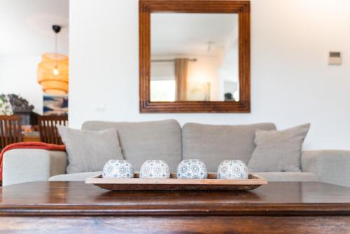 a table with three tea mugs on a tray at Casa Aguila Ibiza in Cala Vadella