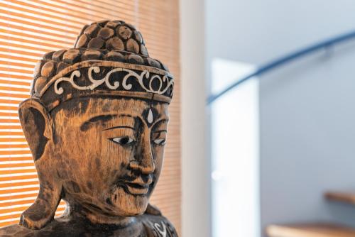 a wooden head statue in front of a building at Casa Aguila Ibiza in Cala Vadella