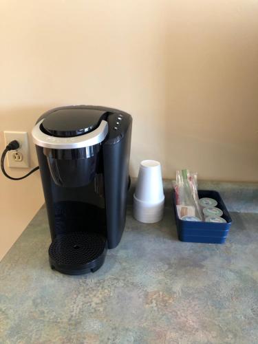 
a blender sitting on top of a counter next to a trash can at Village Inn Motel in Chatham
