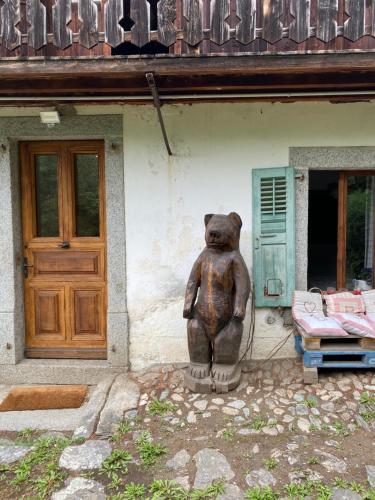a statue of a bear in front of a house at Chalet Le Triollet in Saint-Gervais-les-Bains