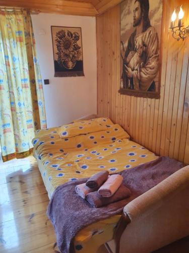 a bedroom with two beds and a painting on the wall at Agroturystyka LAS i WODA in Prażmów