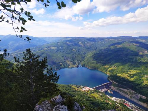 a view of a lake in the mountains with a bridge at Dren Chalet Lux - Banjska stena in Perućac