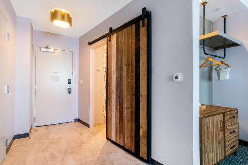 a sliding door in a room with a hallway at Cambria Hotel Nashville Downtown in Nashville