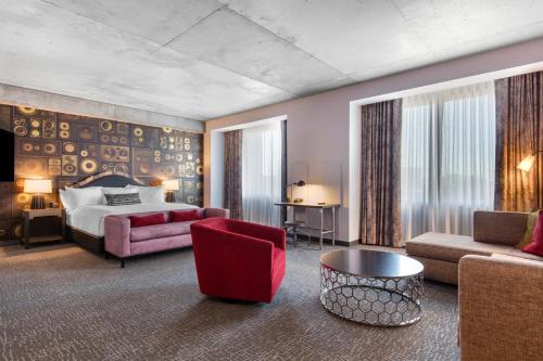 a hotel room with a bed and a couch at Cambria Hotel Nashville Downtown in Nashville